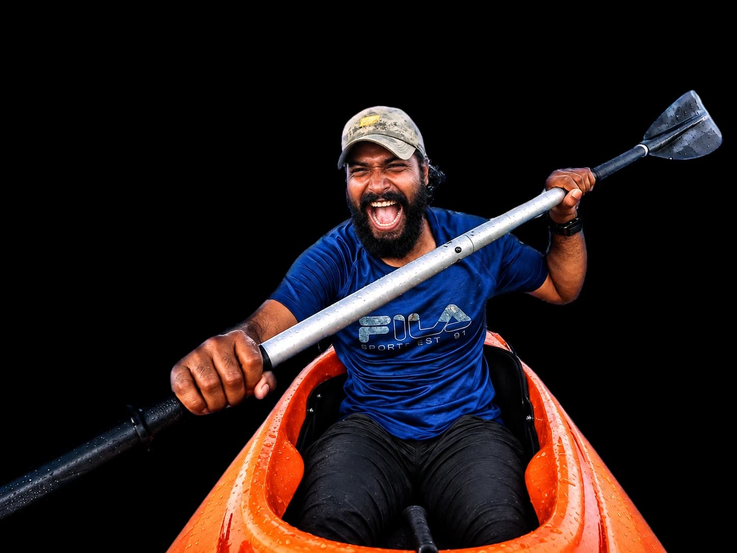 Intiaz Mahmud paddling an orange kayak