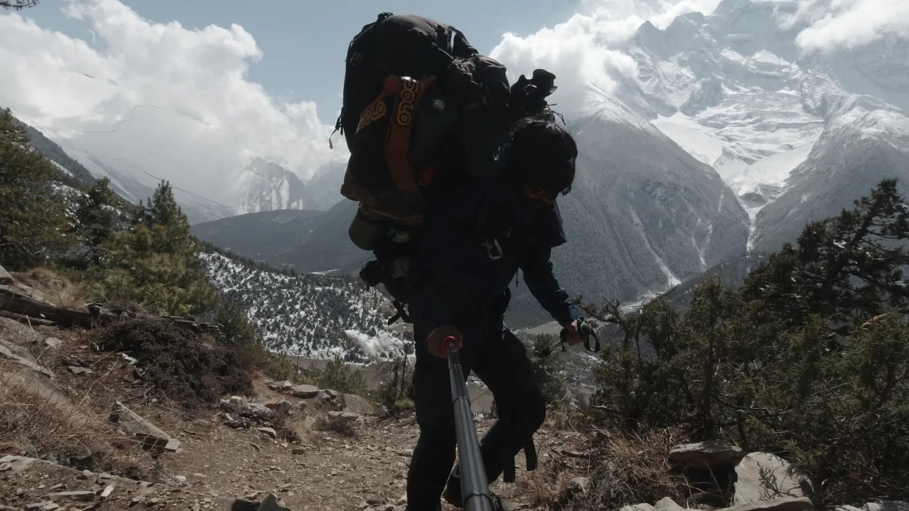 Intiaz Mahmud carries an expedition pack on the trail towards Pisang Peak