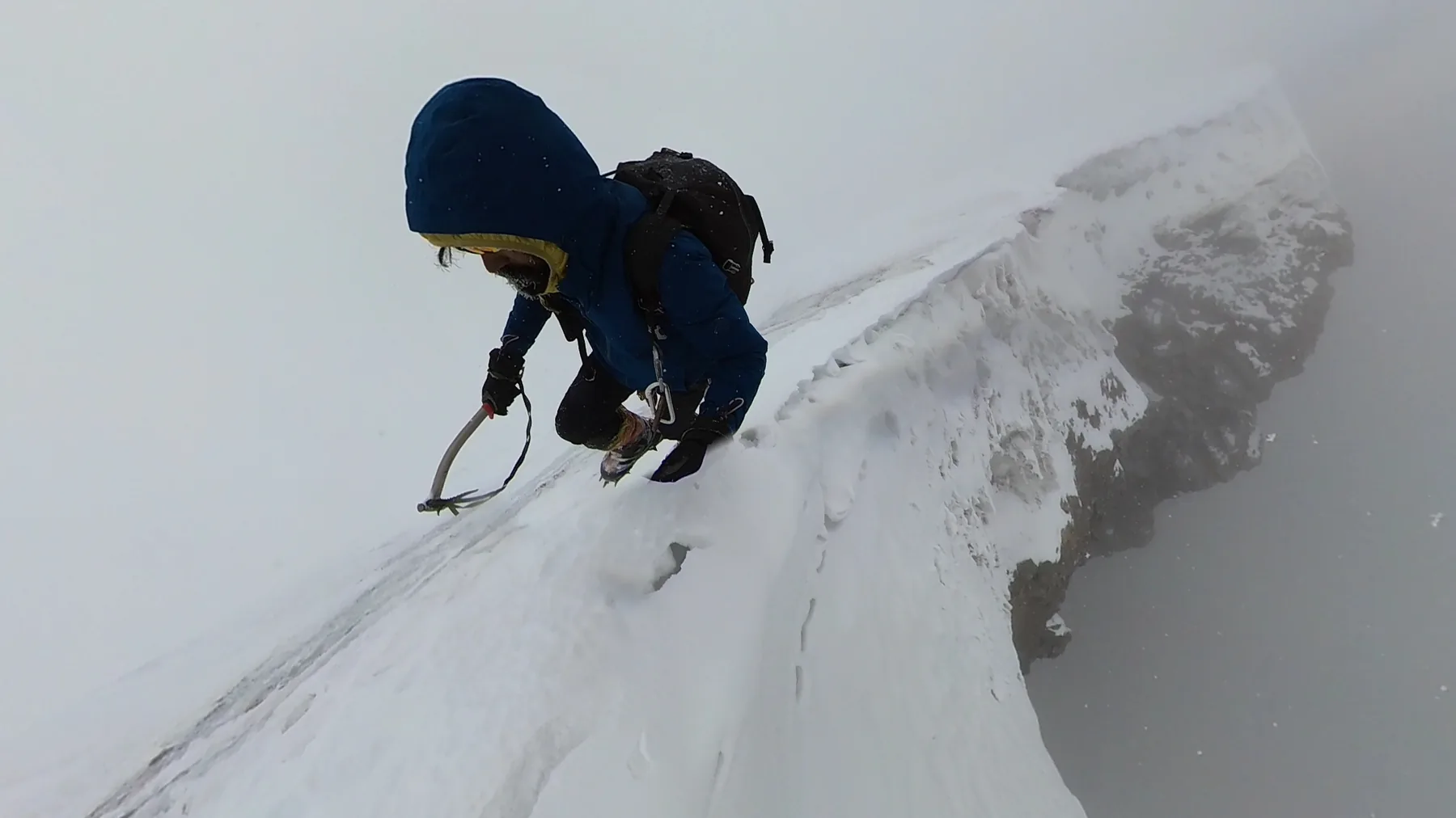 Intiaz Mahmud climbs a very steep snowy slope with crampons and an ice axe